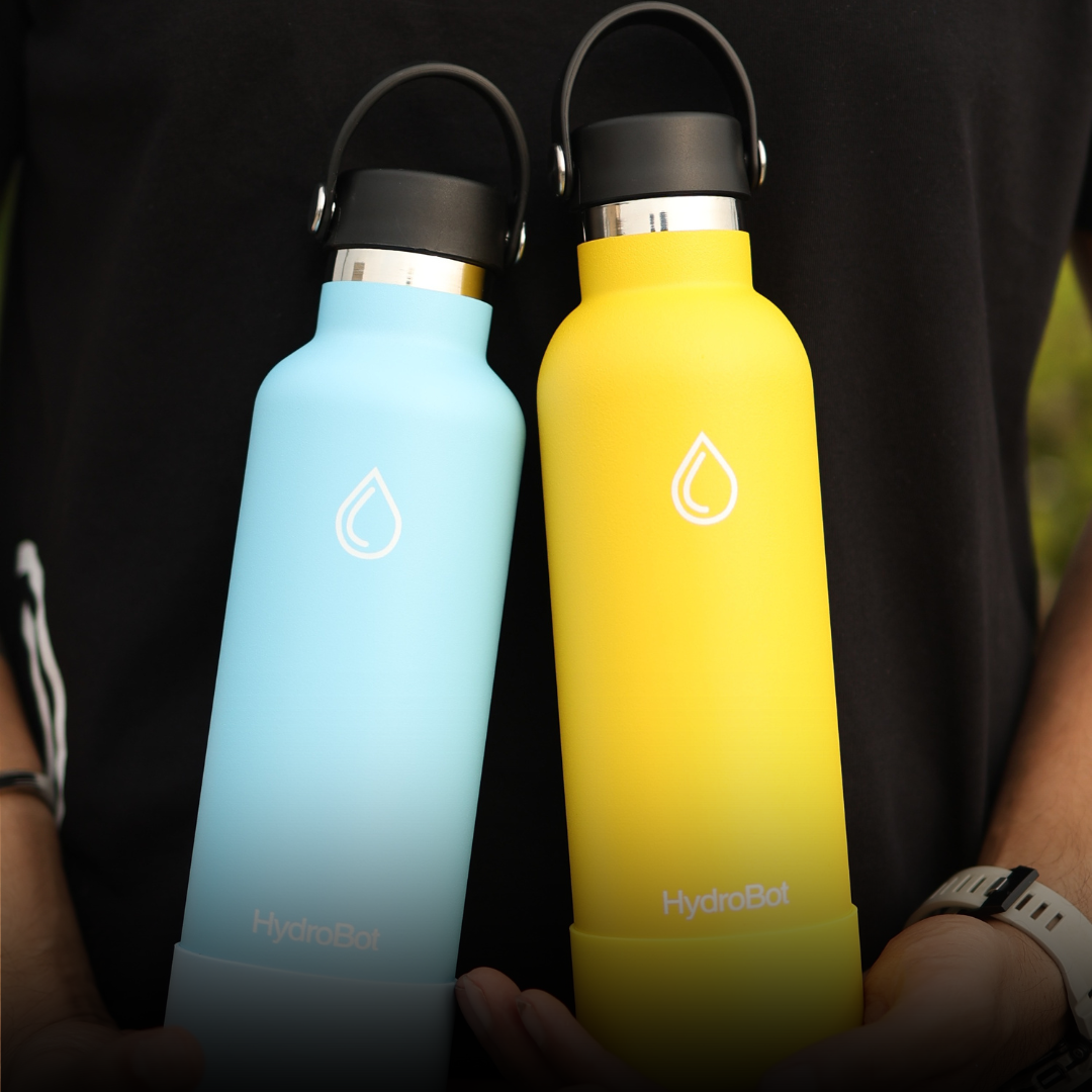 Hand pouring coffee from a black carafe into a glass.