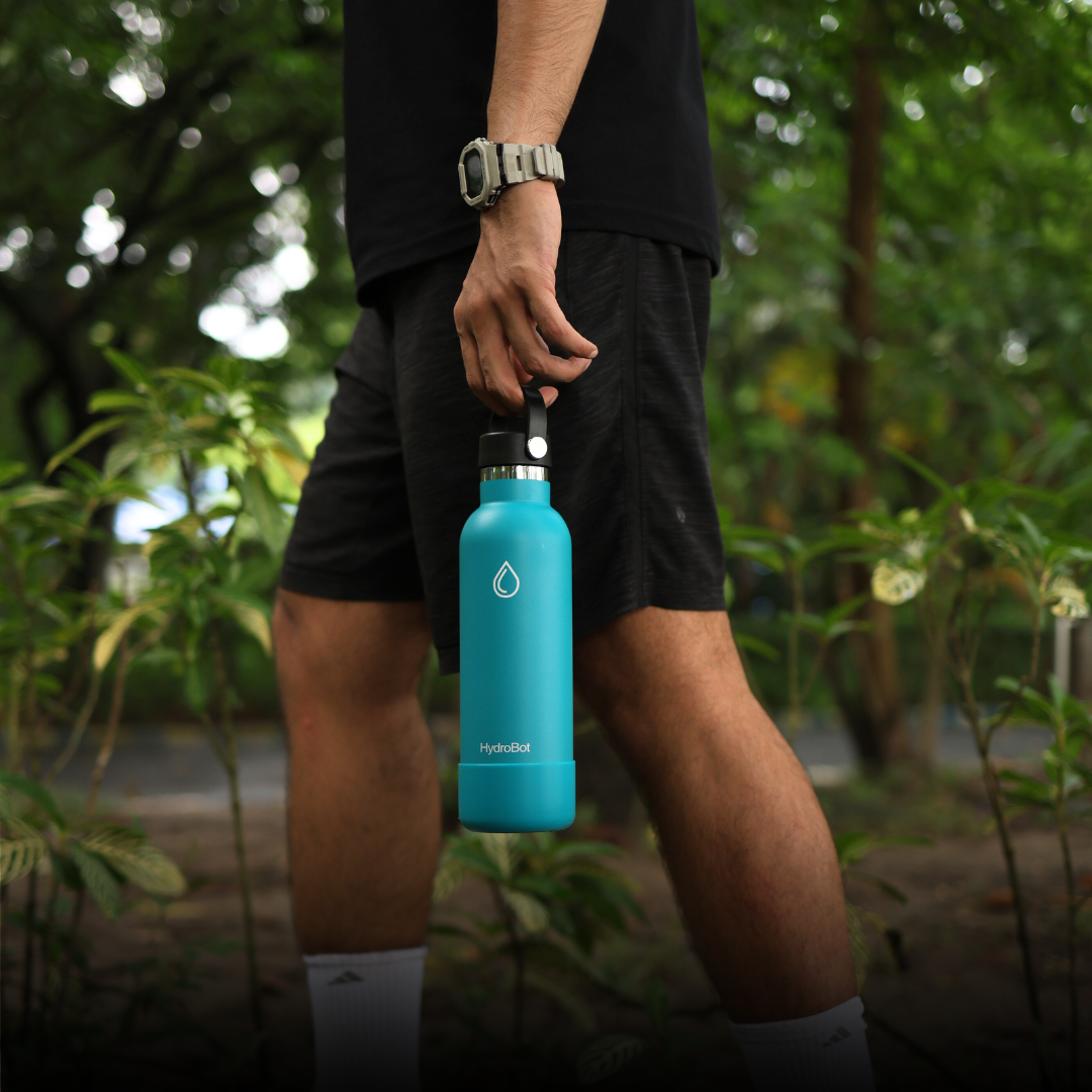 Sleek black French press with wooden handle on a kitchen countertop.