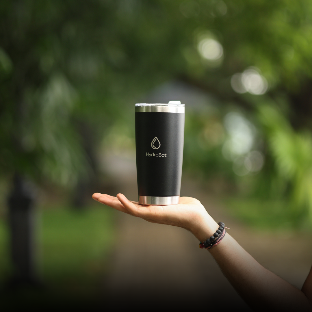 Sleek black French press with wooden handle on a kitchen countertop.