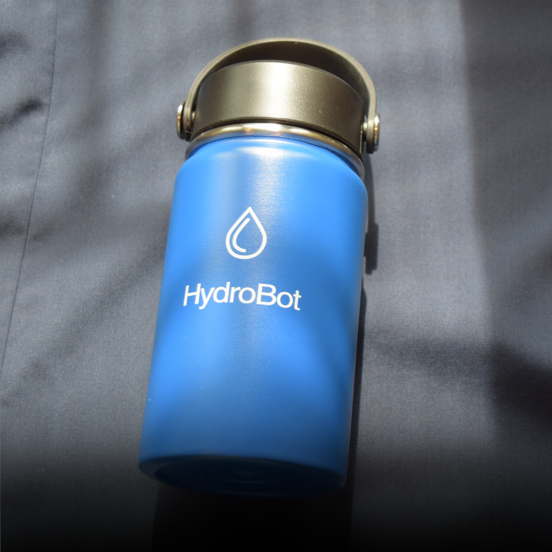 Sleek black French press with wooden handle on a kitchen countertop.