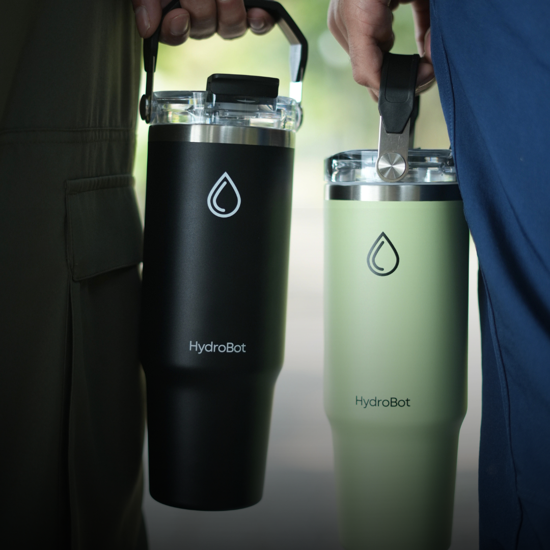 Sleek black French press with wooden handle on a kitchen countertop.