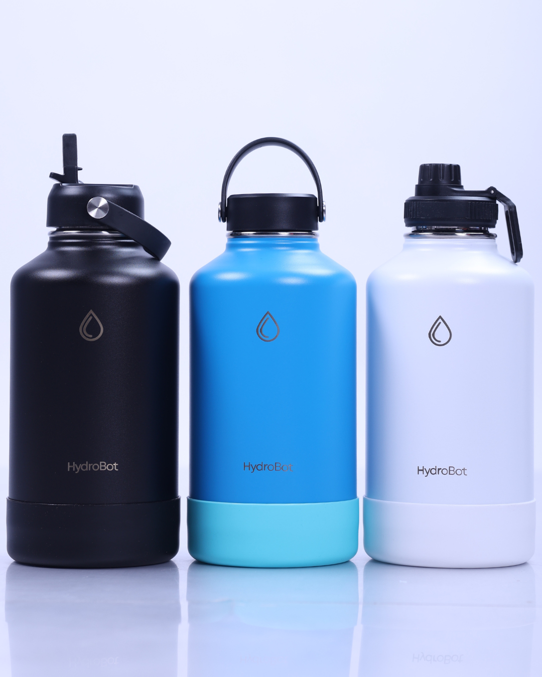 Person holding an orange HydroBot water bottle outdoors with green plants in the background.