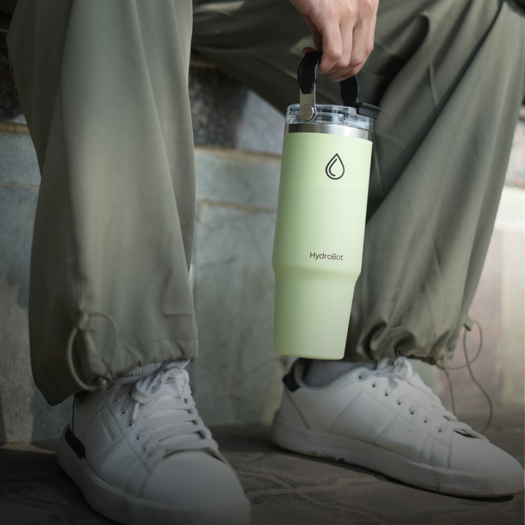 Sleek black French press with wooden handle on a kitchen countertop.